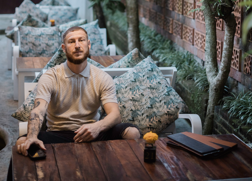 Michael Becker seated at a table, founder-side M&A advisor